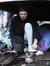 Boy Scout under shelter, cooking